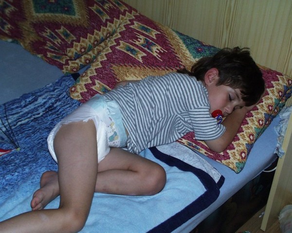 8 year old boy kid wearing diaper and shirt sleeping pacifier older kid in diapers