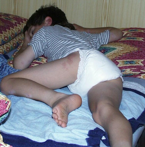8 year old diaper boy tommy sleeping in just pampers diaper and shirt