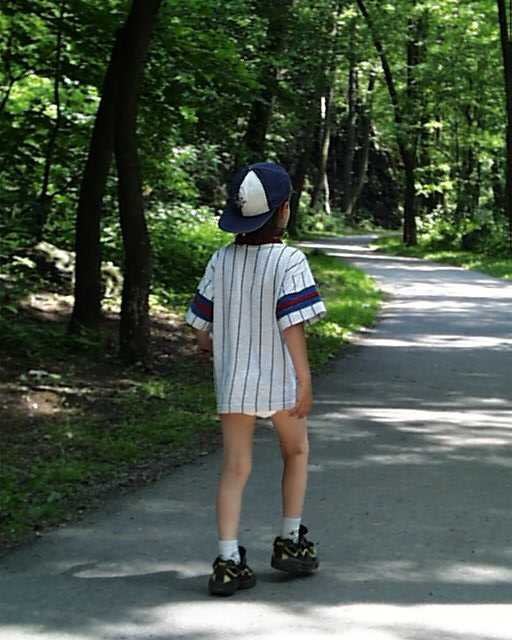 Kid boy 8 year old child older kid wearing diaper and shirt and shoes outside