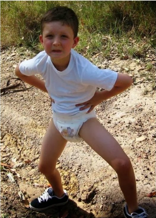 Older kid boy 8 year old boy wearing huggies diapers and shirt outside