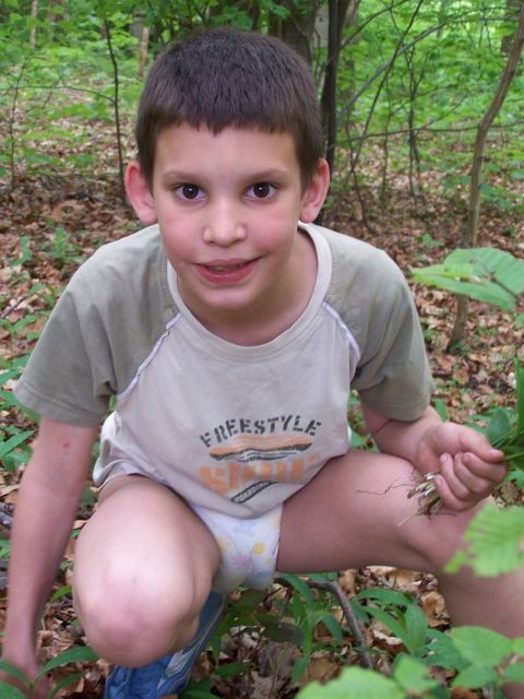 Older kid boy wearing diaper and shoes outside