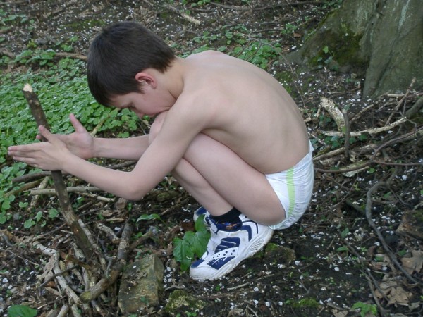 Older kid boy wearing diaper and shoes outside