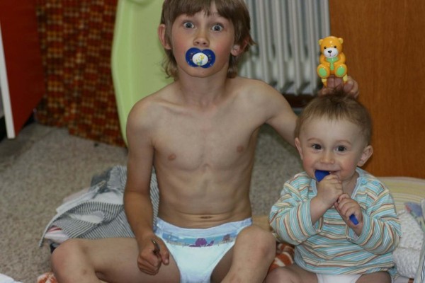 7 or 8 year old boy wearing barney luvs plastic back diapers